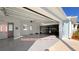 View of the expansive garage space with epoxy floors and access to a half bath and the original two car garage at 149 Sunrise Cove Cir, Ormond Beach, FL 32176