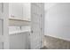 Modern laundry room with a stacked washer and dryer and built-in cabinetry at 149 Sunrise Cove Cir, Ormond Beach, FL 32176