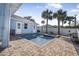 L-shaped pool with spa and brick pavers at 149 Sunrise Cove Cir, Ormond Beach, FL 32176