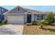 Gray house with a two-car garage and well-manicured lawn at 200 Duke Dr, Deland, FL 32724