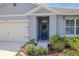 Front entrance with a wreath and well-manicured landscaping at 200 Duke Dr, Deland, FL 32724