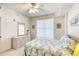 Bedroom with dresser, bed, ceiling fan, and window with blinds at 2403 S Atlantic Ave # 309, Daytona Beach, FL 32118