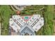 Aerial view showing building, pool, and surrounding landscape at 4 Oceans West Blvd # 206C, Daytona Beach, FL 32118