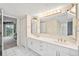 Double vanity bathroom with updated white cabinets at 4 Oceans West Blvd # 206C, Daytona Beach, FL 32118