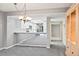 Dining area with mirrored wall and view into the kitchen at 4 Oceans West Blvd # 206C, Daytona Beach, FL 32118