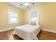 Cozy bedroom featuring wood floors and a ceiling fan at 67 Ormond Shores Dr, Ormond Beach, FL 32176