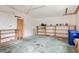 Garage with pegboard, shelves, and a recycling bin at 67 Ormond Shores Dr, Ormond Beach, FL 32176