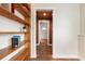 View down a hallway with wood floors and built-in shelving at 67 Ormond Shores Dr, Ormond Beach, FL 32176