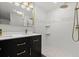 Bathroom with black vanity, white subway tile, and a walk-in shower at 825 Magnolia Ave, Holly Hill, FL 32117