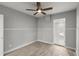 Bedroom with gray walls, wood-look flooring, and a ceiling fan at 825 Magnolia Ave, Holly Hill, FL 32117