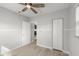 Well-lit bedroom with ceiling fan and closet at 825 Magnolia Ave, Holly Hill, FL 32117