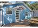 Charming house with a blue facade and a decorative glass front door at 825 Magnolia Ave, Holly Hill, FL 32117