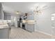 Modern kitchen with gray cabinets, granite countertops, and stainless steel appliances at 825 Magnolia Ave, Holly Hill, FL 32117