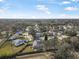 Aerial view of neighborhood with houses and lake at 92 Spinnaker Cir, South Daytona, FL 32119