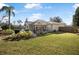 Backyard with screened enclosure and grassy area at 92 Spinnaker Cir, South Daytona, FL 32119