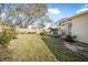 Landscaped backyard with a grassy lawn and flowers at 92 Spinnaker Cir, South Daytona, FL 32119