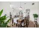 Dining room with wood table, four chairs, and stylish light fixture at 92 Spinnaker Cir, South Daytona, FL 32119