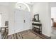 Bright and airy entryway with double doors, wood-look floors, and a console table at 92 Spinnaker Cir, South Daytona, FL 32119