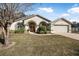 Single story house with arched entryway and attached two-car garage at 92 Spinnaker Cir, South Daytona, FL 32119