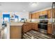 Modern kitchen with stainless steel appliances and wood cabinets at 92 Spinnaker Cir, South Daytona, FL 32119