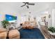 Living room with a blue accent wall, comfortable seating and large TV at 92 Spinnaker Cir, South Daytona, FL 32119