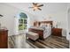 Large main bedroom with hardwood floors and a comfortable bed at 92 Spinnaker Cir, South Daytona, FL 32119