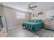 Spacious bedroom with teal bedding, ceiling fan, and wood-look flooring at 1214 Margina Ave, Daytona Beach, FL 32114