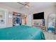 Main bedroom with teal bedding, large closet, and ceiling fan at 1214 Margina Ave, Daytona Beach, FL 32114