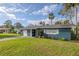 Newly painted blue home with white garage door and green lawn at 1214 Margina Ave, Daytona Beach, FL 32114