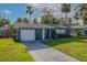 Newly painted blue home with a white garage door and well-maintained lawn at 1214 Margina Ave, Daytona Beach, FL 32114