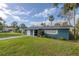 Newly painted blue home with white garage door and green lawn at 1214 Margina Ave, Daytona Beach, FL 32114