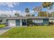 Newly painted home with a white garage door and landscaped yard at 1214 Margina Ave, Daytona Beach, FL 32114