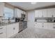 Modern kitchen with white cabinets, granite counters, and stainless steel appliances at 1214 Margina Ave, Daytona Beach, FL 32114