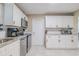 Bright kitchen with granite countertops, stainless steel appliances, and white shaker cabinets at 1214 Margina Ave, Daytona Beach, FL 32114