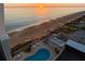 Sunrise over ocean, beach, pool, and coastal homes at 1415 Ocean Shore Blvd # H040, Ormond Beach, FL 32176