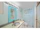 Light teal bathroom with shell-shaped sink at 1415 Ocean Shore Blvd # H040, Ormond Beach, FL 32176