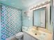 Bathroom with shower and seashell-themed curtain at 1415 Ocean Shore Blvd # H040, Ormond Beach, FL 32176