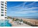 Oceanfront pool and patio area with tables and chairs, offering stunning ocean views at 1415 Ocean Shore Blvd # H040, Ormond Beach, FL 32176