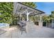 Outdoor kitchen with stone bar and seating at 1778 John Anderson Dr, Ormond Beach, FL 32176