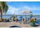 Relaxing waterfront patio with seating and umbrella at 1778 John Anderson Dr, Ormond Beach, FL 32176