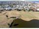 Aerial view showing the location of the property near a golf course and body of water at 200 Country Club Dr, Ormond Beach, FL 32176