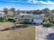 Single-Gathering home with a yellow exterior and a spacious yard at 200 Country Club Dr, Ormond Beach, FL 32176