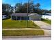 Single-story home with a grassy front yard and driveway at 2050 Anne Cir, South Daytona, FL 32119