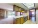 Retro kitchen with wood cabinets and eat-in island at 2050 Anne Cir, South Daytona, FL 32119