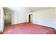 Spacious living room with pink carpet and access to other rooms at 2050 Anne Cir, South Daytona, FL 32119