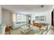 Bright and airy living room featuring a white wicker sofa and coffee table at 2050 Anne Cir, South Daytona, FL 32119