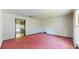 Empty living room with pink carpet and view into kitchen at 2050 Anne Cir, South Daytona, FL 32119