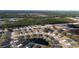 Aerial view of a residential neighborhood with houses, roads, and a pond at 2212 Oconnel Dr, Ormond Beach, FL 32174