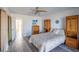 Bedroom with queen-size bed and large wooden wardrobe at 2850 Ocean Shore Blvd # 8, Ormond Beach, FL 32176