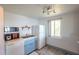 Small kitchen with white appliances and light blue cabinets, view of sink and window at 2850 Ocean Shore Blvd # 8, Ormond Beach, FL 32176